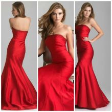 6641: Every girl dreams of the perfect mermaid dress, and this scarlet, strapless one might just be it. The classic mermaid silhouette of this Night Moves style is revamped with sophisticated draping and beading that runs diagonally in curved lines from the right side to the bottom of this stunning style. This gown is elegant, classic, and gives off a 1930’s glamorous air.